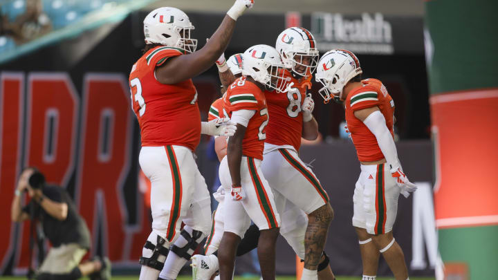 Oct 28, 2023; Miami Gardens, Florida, USA; Miami Hurricanes running back Ajay Allen (28) celebrates with teammates after scoring a touchdown against the Virginia Cavaliers during the third quarter at Hard Rock Stadium. Mandatory Credit: Sam Navarro-USA TODAY Sports