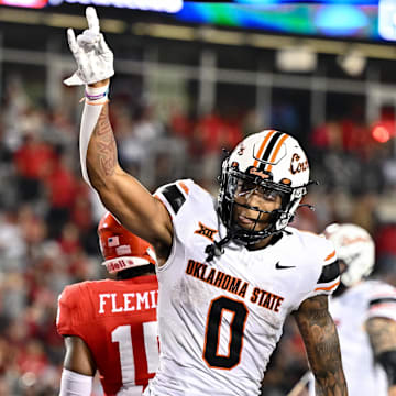 Nov 18, 2023; Houston, Texas, USA; Oklahoma State Cowboys wide receiver Rashod Owens (10) reacts after his touchdown during the fourth quarter against the Houston Cougars at TDECU Stadium. Mandatory Credit: Maria Lysaker-Imagn Images