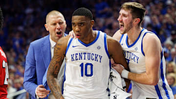 Dec 14, 2024; Lexington, Kentucky, USA; Kentucky Wildcats head coach Mark Pope and forward Andrew Carr (7) celebrate with forward Brandon Garrison (10) during the second half against the Louisville Cardinals at Rupp Arena at Central Bank Center. Mandatory Credit: Jordan Prather-Imagn Images