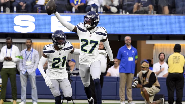 Nov 19, 2023; Inglewood, California, USA;  Seattle Seahawks cornerback Riq Woolen (27) celebrates making an interception against the Los Angeles Rams in the fourth quarter at SoFi Stadium. Mandatory Credit: Robert Hanashiro-USA TODAY Sports