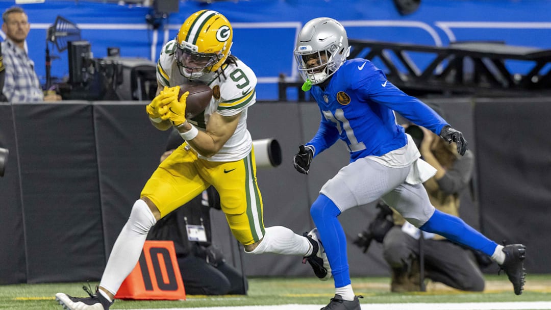 Green Bay Packers wide receiver Christian Watson (9) catches a pass against Detroit Lions cornerback Amik Robertson (21) during the third quarter at Ford Field. Green Bay Packers wide receiver Christian Watson (9) catches a pass against Detroit Lions cornerback Amik Robertson (21) during the third quarter at Ford Field.
