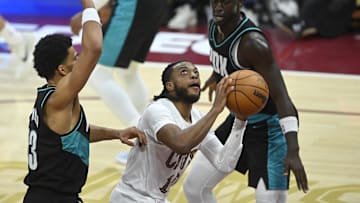 Dec 3, 2025; Cleveland, Ohio, USA; Cleveland Cavaliers guard Darius Garland (10) looks to shoot between Portland Trail Blazers forward Toumani Camara (33) and guard Sidy Cissoko (91) in the fourth quarter at Rocket Arena. Mandatory Credit: David Richard-Imagn Images