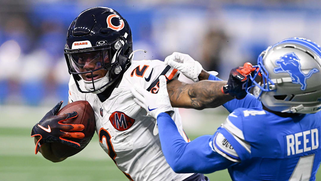 Sep 14, 2025; Detroit, Michigan, USA; Chicago Bears wide receiver DJ Moore (2) carries the ball defended by Detroit Lions cornerback D.J. Reed (4) during the first quarter of the game at Ford Field. Mandatory Credit: Lon Horwedel-Imagn Images