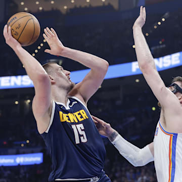 Mar 10, 2025; Oklahoma City, Oklahoma, USA; Denver Nuggets center Nikola Jokic (15) shoots as Oklahoma City Thunder center Isaiah Hartenstein (55) defends during the first quarter at Paycom Center. Mandatory Credit: Alonzo Adams-Imagn Images