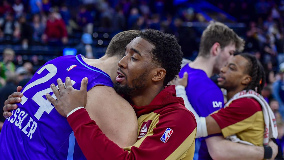 Mar 23, 2025; Salt Lake City, Utah, USA; Cleveland Cavaliers guard Donovan Mitchell (45) embraces Utah Jazz center Walker Kessler (24) after the game at Delta Center. Mandatory Credit: Peter Creveling-Imagn Images