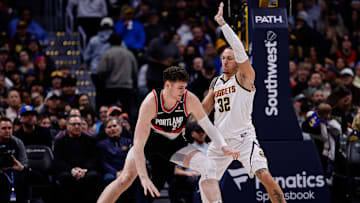 Feb 10, 2025; Denver, Colorado, USA; Portland Trail Blazers center Donovan Clingan (23) controls the ball as Denver Nuggets forward Aaron Gordon (32) guards in the third quarter at Ball Arena. Mandatory Credit: Isaiah J. Downing-Imagn Images