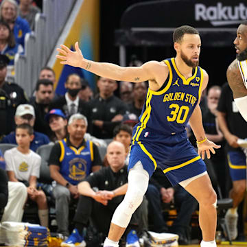 Jan 27, 2024; San Francisco, California, USA; Golden State Warriors guard Stephen Curry (30) defends against Los Angeles Lakers forward LeBron James (23) during overtime at Chase Center. Mandatory Credit: Darren Yamashita-Imagn Images