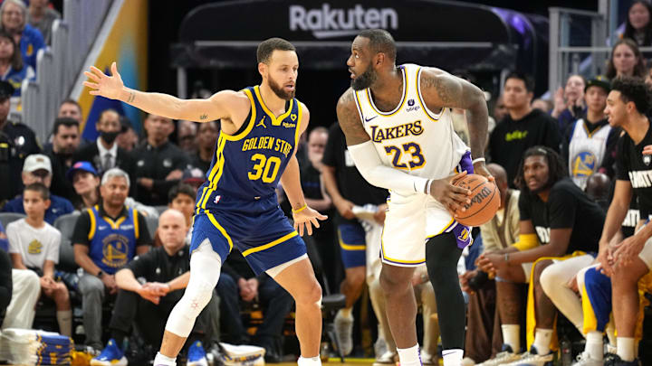 Jan 27, 2024; San Francisco, California, USA; Golden State Warriors guard Stephen Curry (30) defends against Los Angeles Lakers forward LeBron James (23) during overtime at Chase Center. Mandatory Credit: Darren Yamashita-Imagn Images