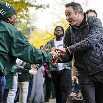 Oct 25, 2025; East Lansing, Michigan, USA; Michigan State head coach Jonathan Smith shakes hands with a fan during the Spartan Walk to Spartan Stadium. Mandatory Credit: Brendan Mullin-Imagn Images