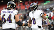Nov 16, 2025; Cleveland, Ohio, USA; Baltimore Ravens quarterback Lamar Jackson (8) warms-up with center Tyler Linderbaum (64) prior to a game against the Cleveland Browns at Huntington Bank Field. Mandatory Credit: Scott Galvin-Imagn Images
