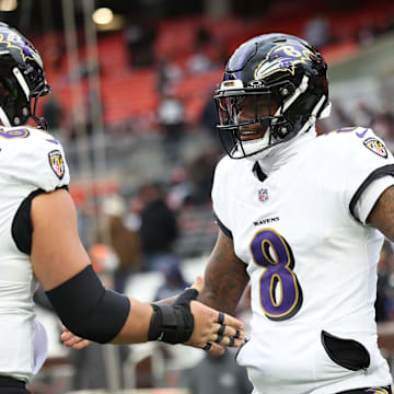 Nov 16, 2025; Cleveland, Ohio, USA; Baltimore Ravens quarterback Lamar Jackson (8) warms-up with center Tyler Linderbaum (64) prior to a game against the Cleveland Browns at Huntington Bank Field. Mandatory Credit: Scott Galvin-Imagn Images