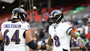 Nov 16, 2025; Cleveland, Ohio, USA; Baltimore Ravens quarterback Lamar Jackson (8) warms-up with center Tyler Linderbaum (64) prior to a game against the Cleveland Browns at Huntington Bank Field. Mandatory Credit: Scott Galvin-Imagn Images