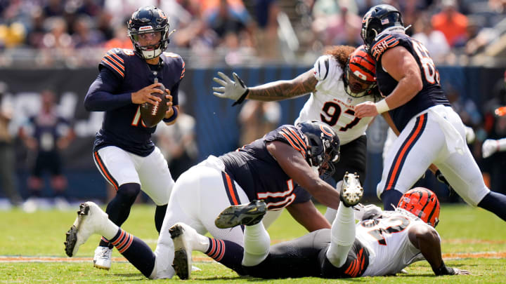 Caleb Williams scrambles around inside the pocket before moving out of it and throwing against the Bengals.