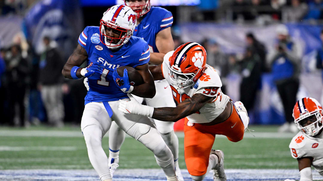 Dec 7, 2024; Charlotte, NC, USA; DUPLICATE***Southern Methodist Mustangs running back Brashard Smith (1) runs against Clemson Tigers defensive end A.J. Hoffler (99) during the first quarter in the 2024 ACC Championship game at Bank of America Stadium.