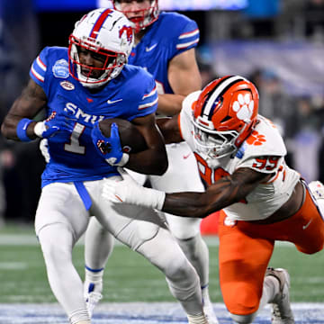 Dec 7, 2024; Charlotte, NC, USA; DUPLICATE***Southern Methodist Mustangs running back Brashard Smith (1) runs against Clemson Tigers defensive end A.J. Hoffler (99) during the first quarter in the 2024 ACC Championship game at Bank of America Stadium.