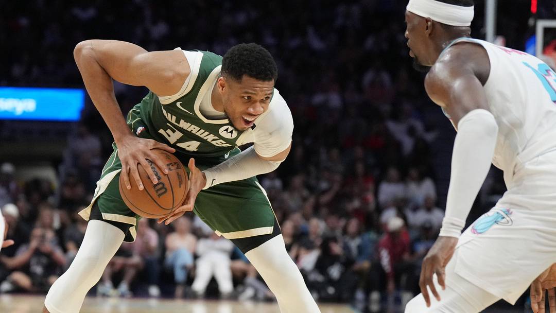 Apr 5, 2025; Miami, Florida, USA;  Milwaukee Bucks forward Giannis Antetokounmpo (34) looks to pass the ball as Miami Heat center Bam Adebayo (13) defends during the second half at Kaseya Center. Mandatory Credit: Jim Rassol-Imagn Images