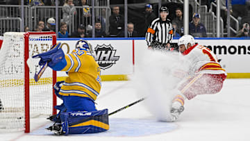 Jan 10, 2023; St. Louis, Missouri, USA;  Calgary Flames left wing Milan Lucic (17) scores against St. Louis Blues goaltender Jordan Binnington (50) during the first period at Enterprise Center. Mandatory Credit: Jeff Curry-Imagn Images