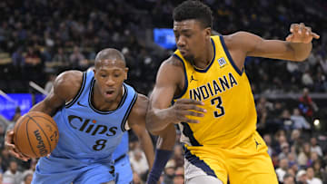 Feb 6, 2025; Inglewood, California, USA;  Los Angeles Clippers guard Kris Dunn (8) beats Indiana Pacers center Thomas Bryant (3) to a rebound in the second half at Intuit Dome. Mandatory Credit: Jayne Kamin-Oncea-Imagn Images