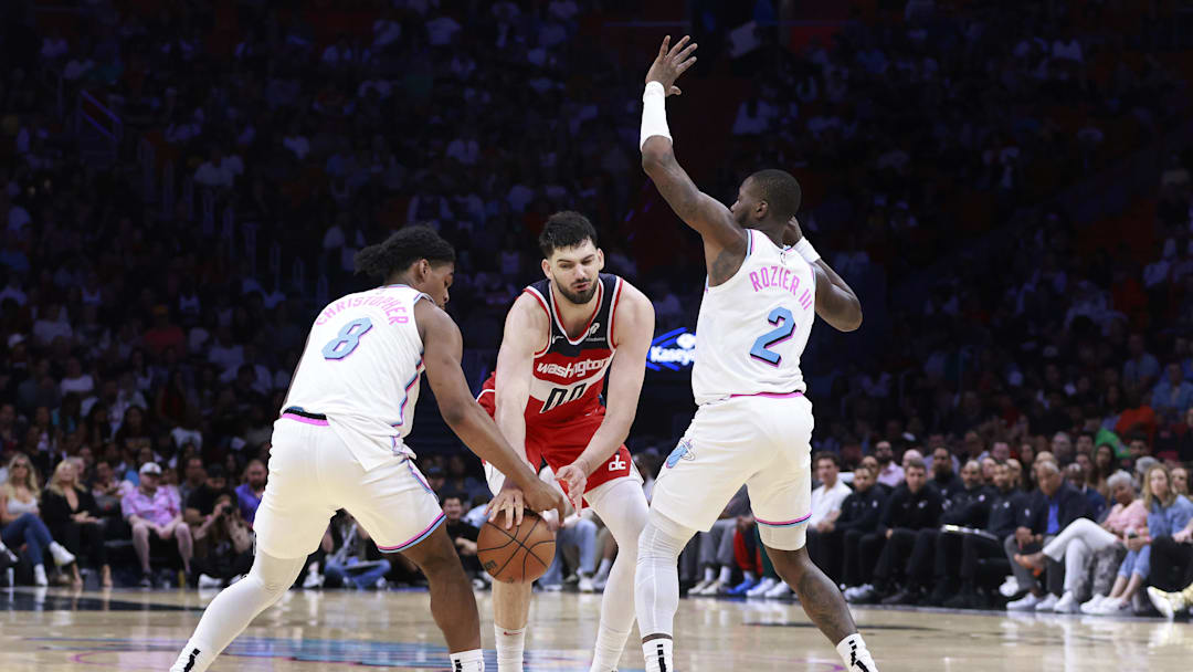 Apr 13, 2025; Miami, Florida, USA;  Miami Heat guard Josh Christopher (8) strips the ball from Washington Wizards forward Tristan Vukcevic (00)during the second half at Kaseya Center. Mandatory Credit: Rhona Wise-Imagn Images