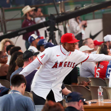 Jul 14, 2024; Ft. Worth, TX, USA;  Christian Moore celebrates with fans after being selected by the Los Angeles Angels as the eight player taken during the first round of the MLB Draft at Cowtown Coliseum. Mandatory Credit: Kevin Jairaj-USA TODAY Sports