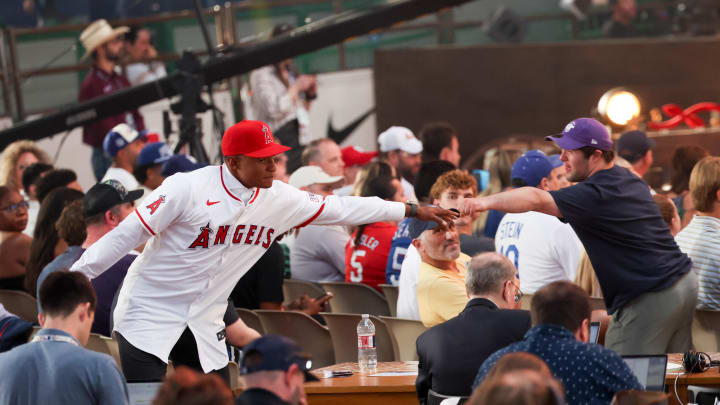 Jul 14, 2024; Ft. Worth, TX, USA;  Christian Moore celebrates with fans after being selected by the Los Angeles Angels as the eight player taken during the first round of the MLB Draft at Cowtown Coliseum. Mandatory Credit: Kevin Jairaj-USA TODAY Sports