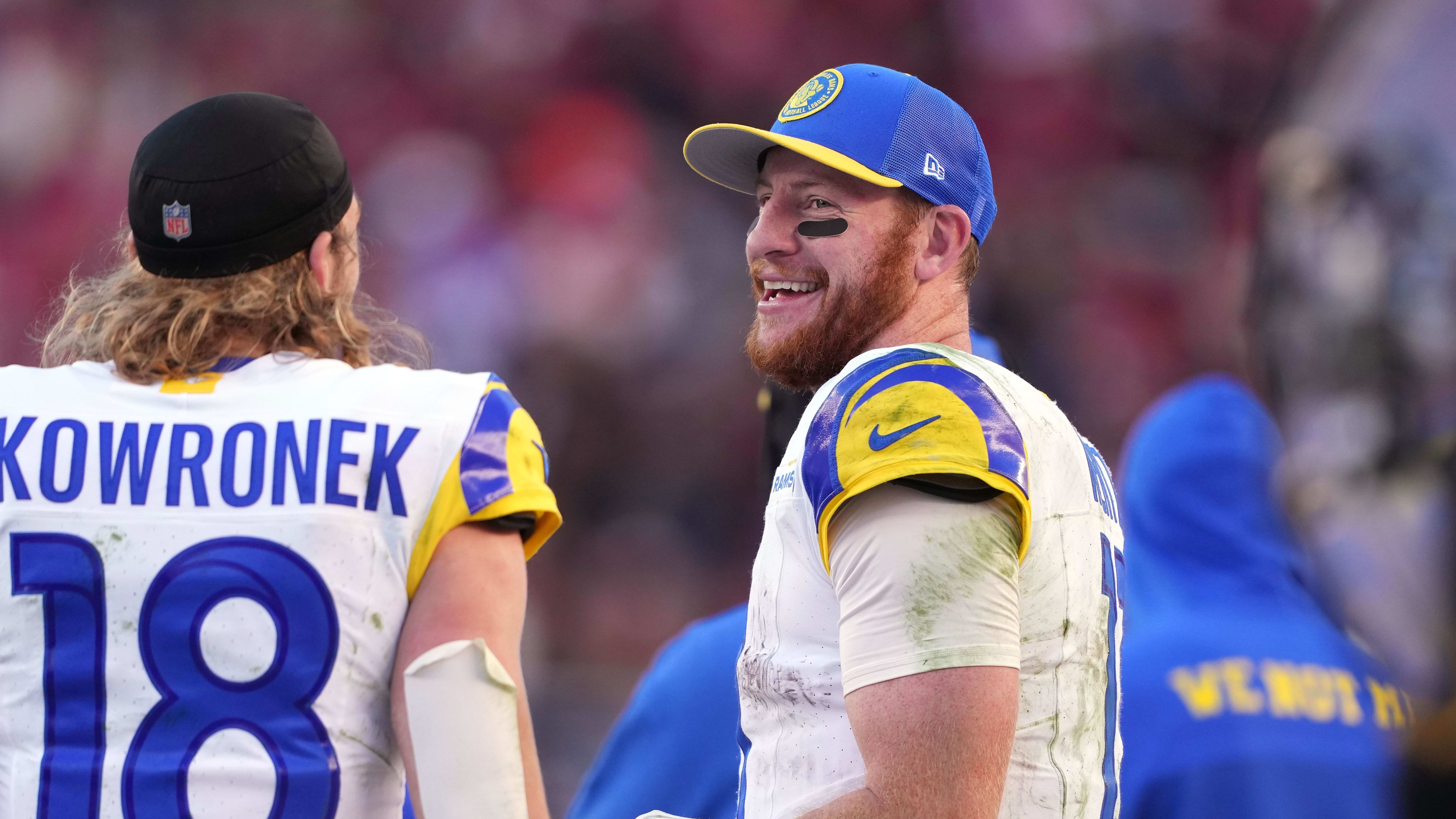 Los Angeles Rams quarterback Carson Wentz talks with receiver Bennett Skowronek.