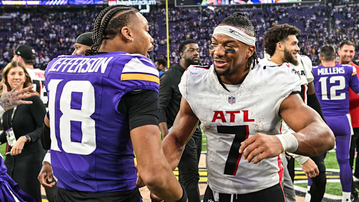 Dec 8, 2024; Minneapolis, Minnesota, USA; Atlanta Falcons running back Bijan Robinson (7) and Minnesota Vikings wide receiver Justin Jefferson (18) greet each other after the game at U.S. Bank Stadium.