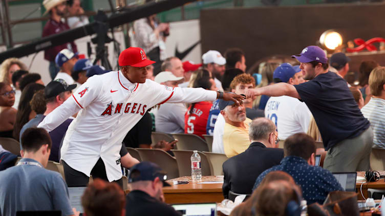 Jul 14, 2024; Ft. Worth, TX, USA;  Christian Moore celebrates with fans after being selected by the Los Angeles Angels as the eight player taken during the first round of the MLB Draft at Cowtown Coliseum. Mandatory Credit: Kevin Jairaj-USA TODAY Sports