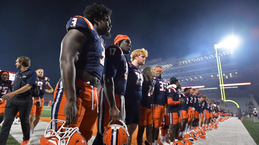 Aug 29, 2024; Champaign, Illinois, USA;  The Illinois Fighting Illini team salute their fans at the final of Thursday’s 45-0 game over Eastern Illinois Panthers at  Memorial Stadium. Mandatory Credit: Ron Johnson-USA TODAY Sports