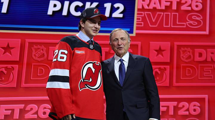 Jun 26, 2026; Buffalo, New York, USA; Alexander Command reacts beside NHL commissioner Gary Bettman after being selected with the twelfth pick in the first round of the 2026 NHL Draft by the New Jersey Devils at KeyBank Center. Mandatory Credit: Timothy T. Ludwig-Imagn Images