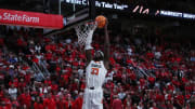 Mar 4, 2023; Lubbock, Texas, USA;  Oklahoma State Cowboys forward Moussa Cisse (33) slam dunks the