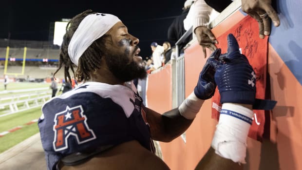 Feb 18, 2023; Houston, TX, USA; Houston Roughnecks  linebacker Tavante Beckett (11) signs an autograph after there Roughnecks defeated the Guardians Orlando  at TDECU Stadium. Mandatory Credit: Thomas Shea-USA TODAY Sports

