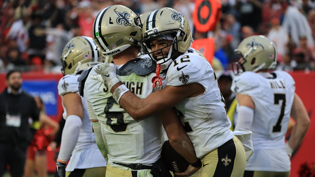 Dec 7, 2025; Tampa, Florida, USA; New Orleans Saints quarterback Tyler Shough (6) and wide receiver Chris Olave (12) celebrate a touchdown during the fourth quarter against the Tampa Bay Buccaneers at Raymond James Stadium. Mandatory Credit: Kim Klement Neitzel-Imagn Images