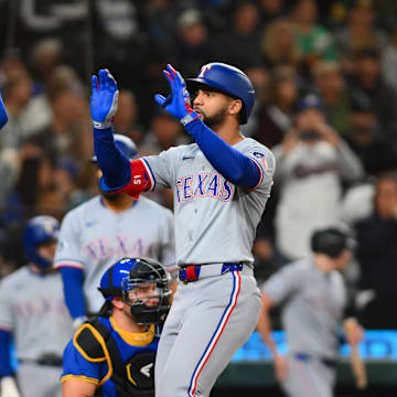 Sep 14, 2024; Seattle, Washington, USA; Texas Rangers catcher Carson Kelly (18) and center fielder Leody Taveras (3) celebrate after Taveras hit a 2-run home run against the Seattle Mariners during the third inning at T-Mobile Park. Mandatory Credit: Steven Bisig-Imagn Images