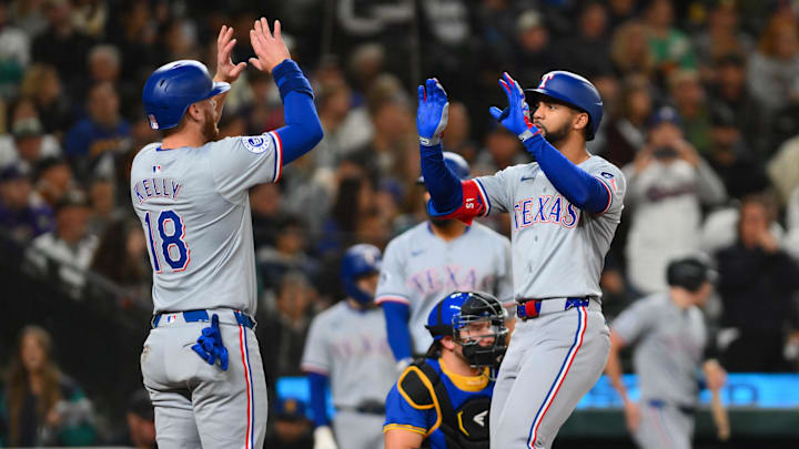 Sep 14, 2024; Seattle, Washington, USA; Texas Rangers catcher Carson Kelly (18) and center fielder Leody Taveras (3) celebrate after Taveras hit a 2-run home run against the Seattle Mariners during the third inning at T-Mobile Park. Mandatory Credit: Steven Bisig-Imagn Images