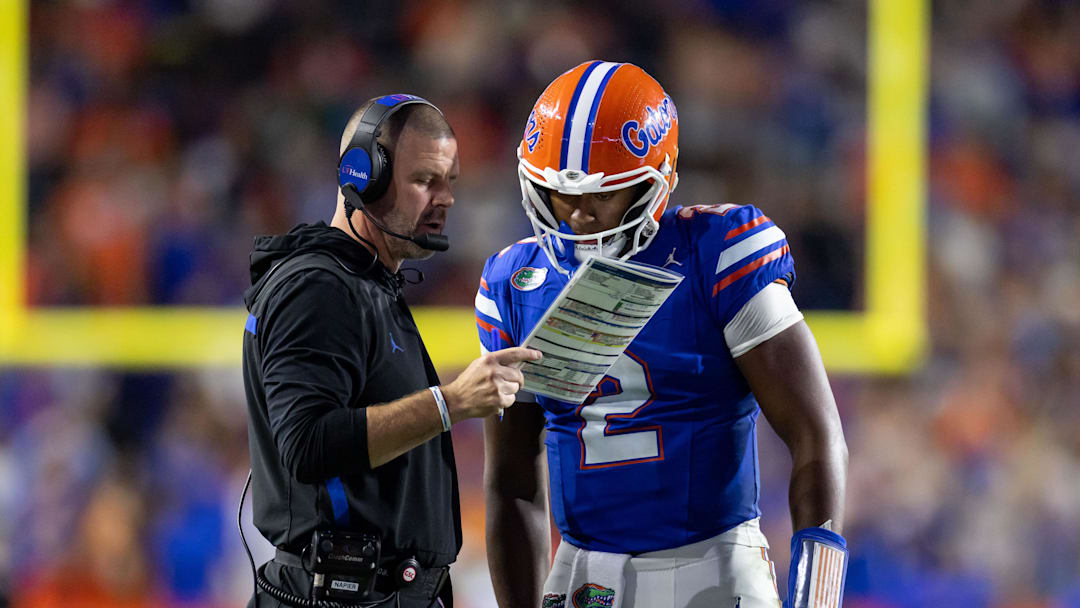 Oct 19, 2024; Gainesville, Florida, USA; Florida Gators head coach Billy Napier and Florida Gators quarterback DJ Lagway (2) review a play against the Kentucky Wildcats during the second half at Ben Hill Griffin Stadium. Mandatory Credit: Matt Pendleton-Imagn Images