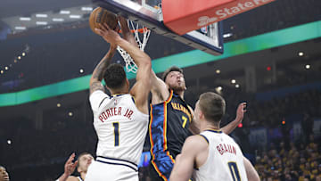 May 5, 2025; Oklahoma City, Oklahoma, USA; Oklahoma City Thunder forward Chet Holmgren (7) blocks a shot by Denver Nuggets forward Michael Porter Jr. (1) during the first quarter during game one of the second round for the 2025 NBA Playoffs at Paycom Center. Mandatory Credit: Alonzo Adams-Imagn Images