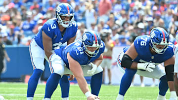 Aug 9, 2025; Orchard Park, New York, USA; New York Giants quarterback Russell Wilson (3) at the line of scrimmage with center John Michael Schmitz Jr. (61) and guard Jon Runyan (76) in the first quarter against the Buffalo Bills at Highmark Stadium.  