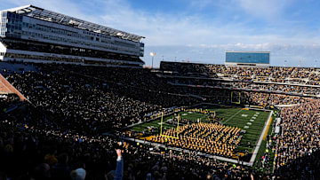 Fans watch a military flyover during the National Anthem before kickoff between Iowa football and Michigan State Nov. 22, 2025 at Kinnick Stadium in Iowa City, Iowa.