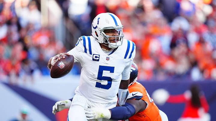 Dec 15, 2024; Denver, Colorado, USA; Indianapolis Colts quarterback Anthony Richardson (5) runs past the tackle of Denver Broncos defensive tackle Malcolm Roach (97) in the second quarter at Empower Field at Mile High. Mandatory Credit: Ron Chenoy-Imagn Images