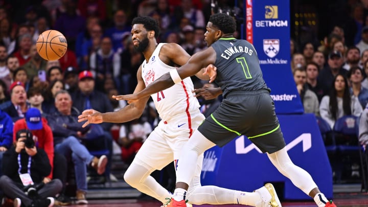 Nov 19, 2022; Philadelphia, Pennsylvania, USA; Philadelphia 76ers center Joel Embiid (21) and Minnesota Timberwolves guard Anthony Edwards (1) reach for a loose ball in the first quarter at Wells Fargo Center. Mandatory Credit: Kyle Ross-USA TODAY Sports