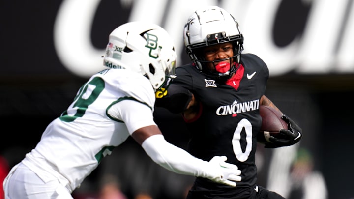 Cincinnati Bearcats wide receiver Braden Smith (0) stiff arms Baylor Bears safety Romario Noel (29) on a carry in the first quarter during a college football game between the Baylor Bears and the Cincinnati Bearcats, Saturday, Oct. 21, 2023, at Nippert Stadium in Cincinnati. Cincinnati Bearcats wide receiver Braden Smith (0) stiff arms Baylor Bears safety Romario Noel (29) on a carry in the first quarter during a college football game between the Baylor Bears and the Cincinnati Bearcats, Saturday, Oct. 21, 2023, at Nippert Stadium in Cincinnati.