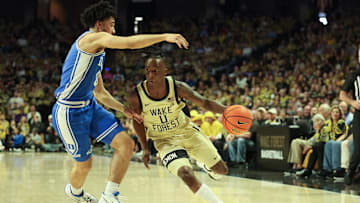 Feb 24, 2024; Winston-Salem, North Carolina, USA;  Wake Forest Demon Deacons guard Kevin Miller (0) drives the ball against Duke Blue Devils guard Jared McCain (0) during the first half at Lawrence Joel Veterans Memorial Coliseum. Mandatory Credit: Cory Knowlton-Imagn Images