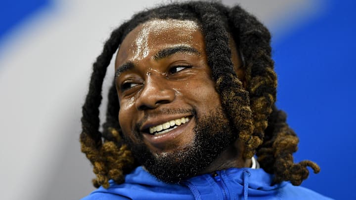 Detroit Lions linebacker James Houston laughs while talking to a teammate on the bench during pre-game warmups 