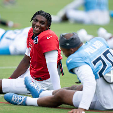 Tennessee Titans quarterback Cam Ward (1) and running back Tony Pollard (20) go through stretches during Day 6 of training camp at Ascension Saint Thomas Sports Park in Nashville, Tenn., Friday, Aug. 1, 2025.