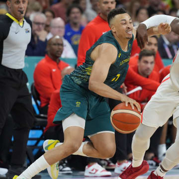 Jul 30, 2024; Villeneuve-d'Ascq, France; Australia point guard Dante Exum (11) in action against Canada guard Luguentz Dort (0) in a men's group stage basketball match during the Paris 2024 Olympic Summer Games at Stade Pierre-Mauroy. Mandatory Credit: John David Mercer-USA TODAY Sports