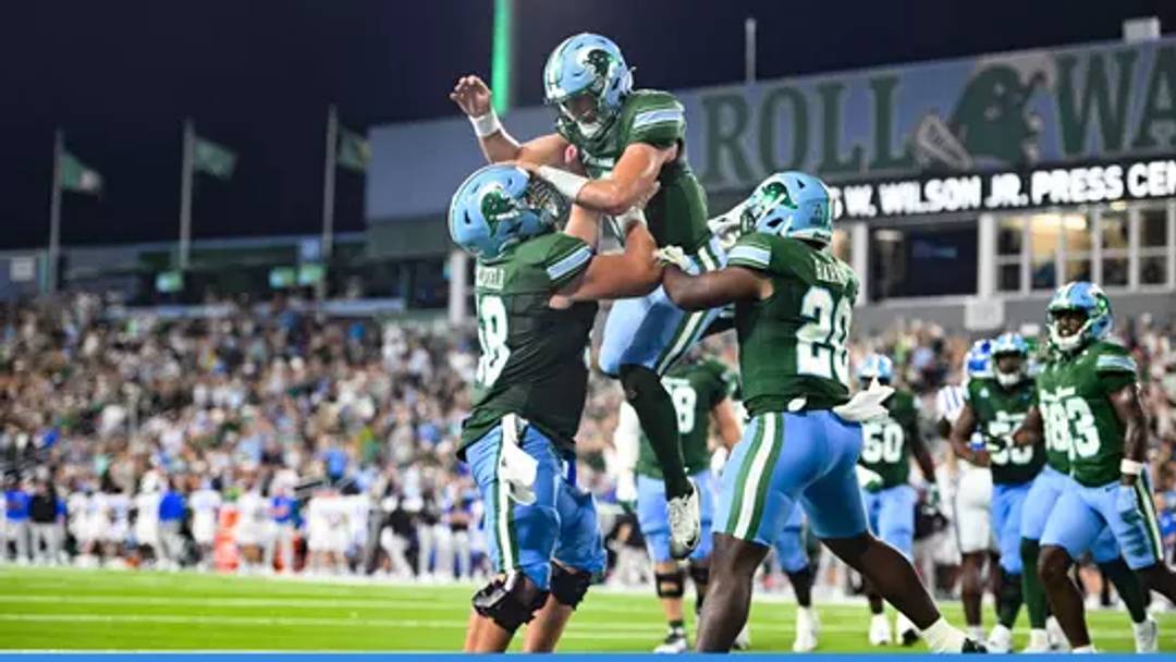 Sept 13, 2025; New Orleans, LA, USA; Former Tulane quarterback, Jake Retzlaff (middle, jumping) celebrates with teammates Jack Hollifield (left, 58) and Arnold Barnes III (right, 20) after scoring a touchdown at Yulman Stadium. Mandatory Credit: Parker Waters-Tulane Athletics Sept 13, 2025; New Orleans, LA, USA; Former Tulane quarterback, Jake Retzlaff (middle, jumping) celebrates with teammates Jack Hollifield (left, 58) and Arnold Barnes III (right, 20) after scoring a touchdown at Yulman Stadium. Mandatory Credit: Parker Waters-Tulane Athletics