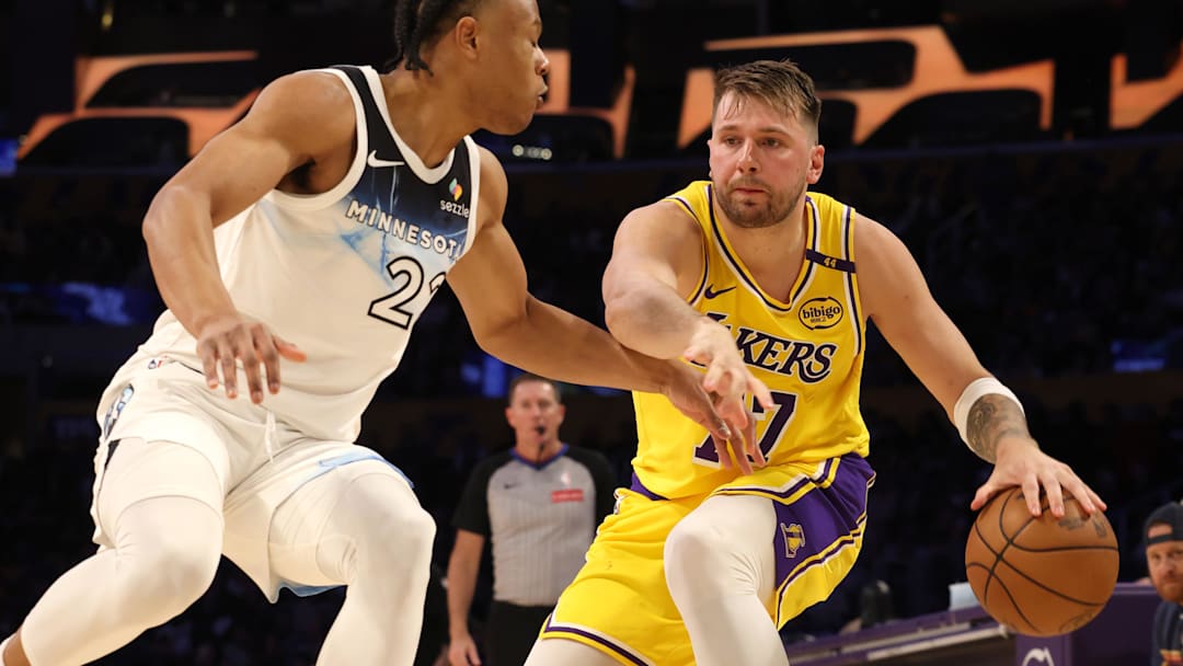 Feb 27, 2025; Los Angeles, California, USA; Los Angeles Lakers guard Luka Doncic (77) dribbles against Minnesota Timberwolves guard Jaylen Clark (22) during the second quarter at Crypto.com Arena. Mandatory Credit: Jason Parkhurst-Imagn Images