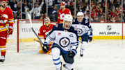 Oct 20, 2025; Calgary, Alberta, CAN; Winnipeg Jets center Jonathan Toews (19) celebrates after scoring a goal on Calgary Flames goaltender Dustin Wolf (32) during the third period at Scotiabank Saddledome. Mandatory Credit: Brett Holmes-Imagn Images
