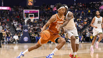 Mar 12, 2025; Nashville, TN, USA;  Texas Longhorns guard Tre Johnson (20) dribbles past Vanderbilt Commodores guard MJ Collins Jr. (2) during the second half at Bridgestone Arena. Mandatory Credit: Steve Roberts-Imagn Images